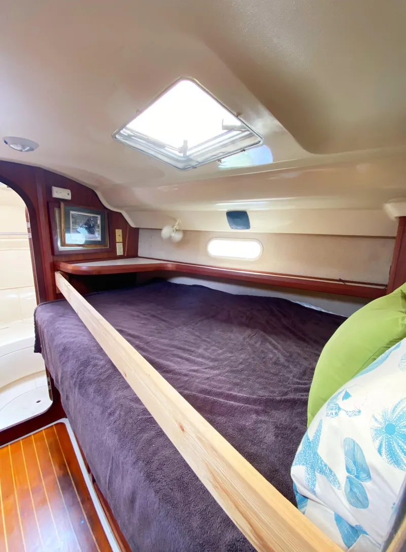 Slide: The Image of Cozy cabin interior of a 1997 Hunter 430 sailboat with skylight and wooden accents. - 28