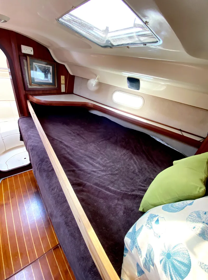 Slide: The Image of Cozy cabin interior of 1997 Hunter 430 sailboat with wooden flooring and skylight. - 30