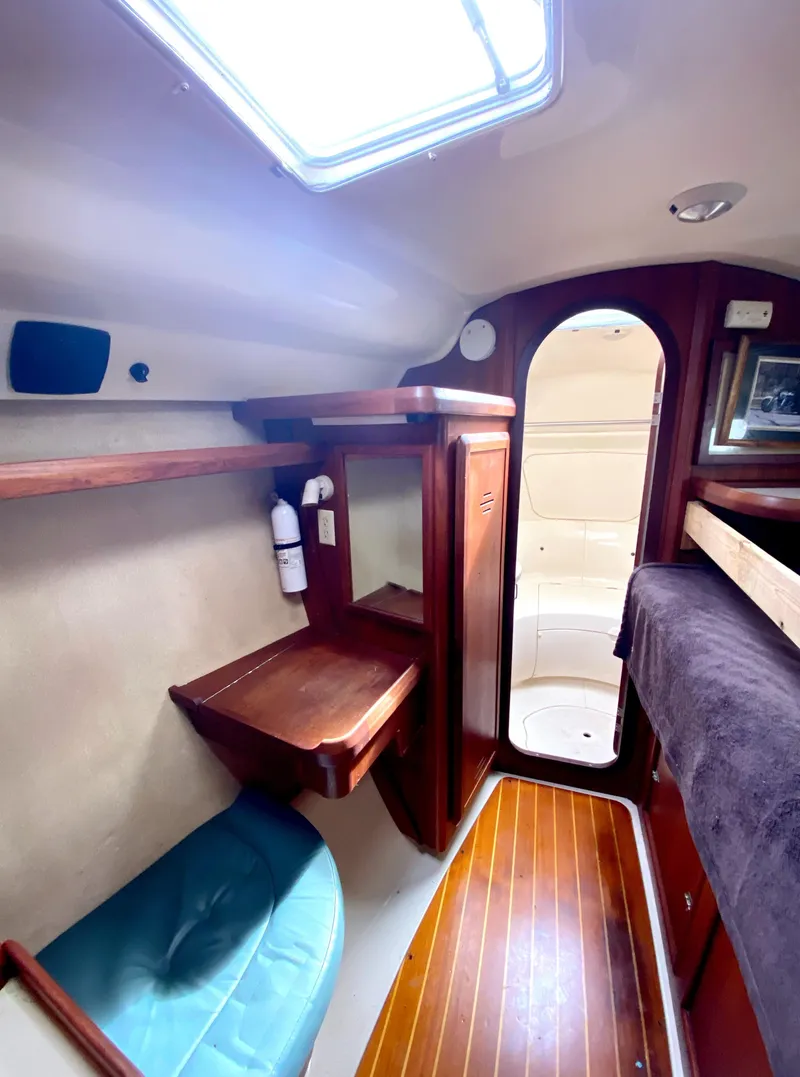 Slide: The Image of Interior of 1997 Hunter 430 sailboat with wooden accents and seating. - 31