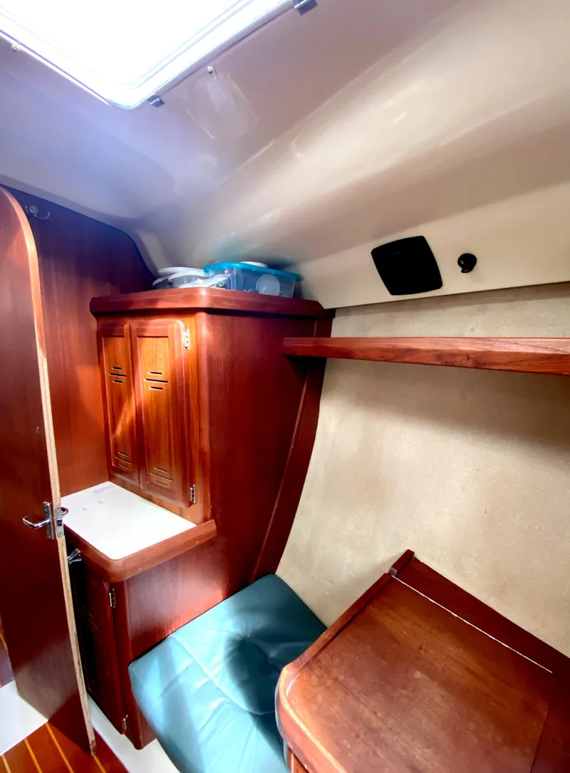 Slide: The Image of Cozy cabin interior of a 1997 Hunter 430 sailboat with wooden furnishings. - 32