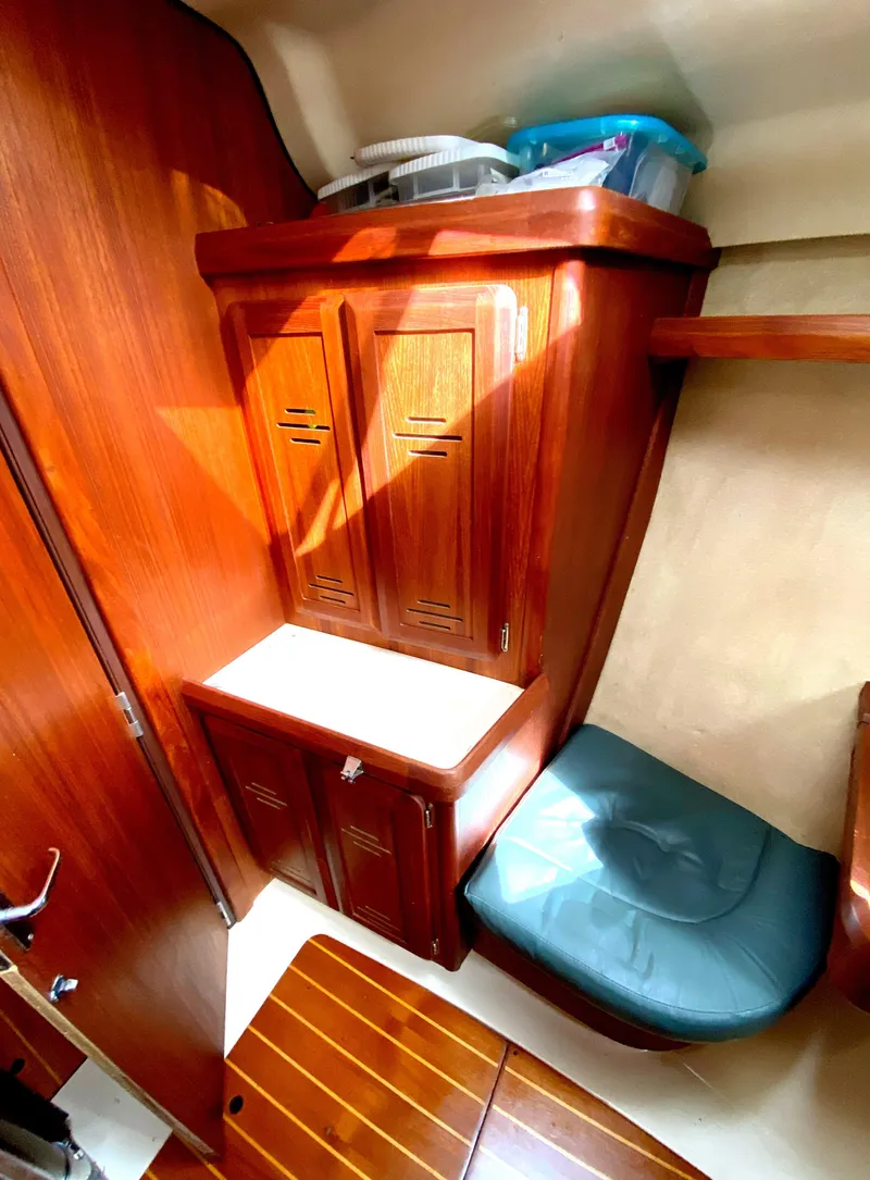 Slide: The Image of Hunter 430 yacht interior, 1997 model, featuring wooden cabinetry and seating area. - 33