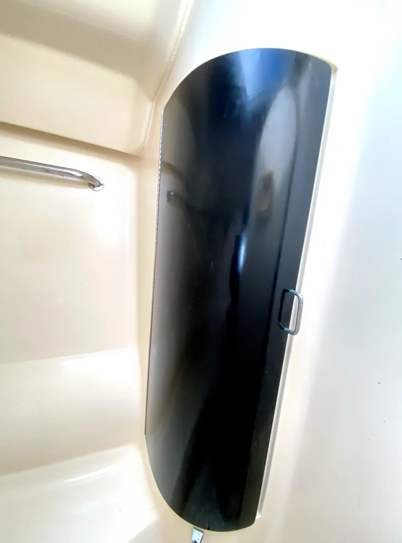 Slide: The Image of 1997 Hunter 430 boat interior with sleek black panel and beige surroundings. - 36
