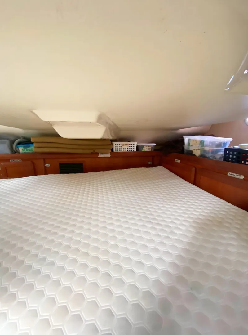 Slide: The Image of Cozy cabin interior of 1997 Hunter 430 sailboat with storage and bedding. - 40