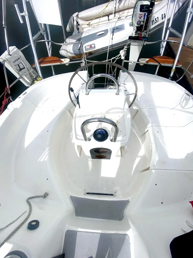 Slide: The Image of 1997 Hunter 430 sailboat cockpit with steering wheel and navigation equipment. - 46