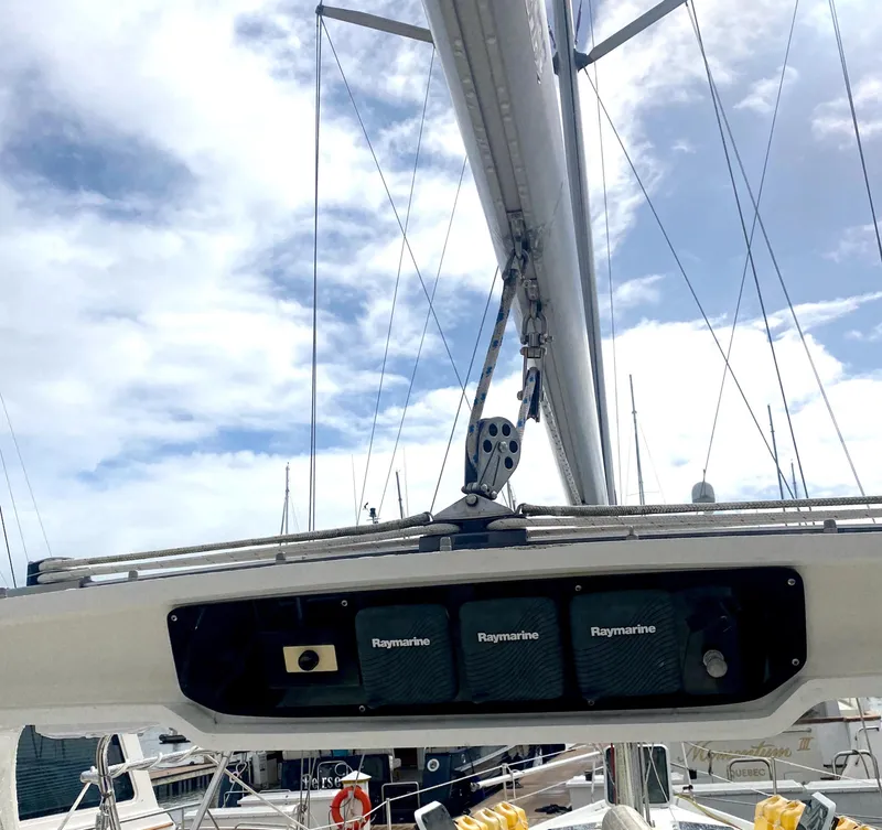 Slide: The Image of Hunter 430 sailboat mast with Raymarine equipment, 1997 model, under a partly cloudy sky. - 47