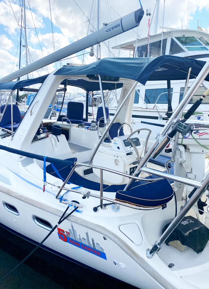 Slide: The Image of 1997 Hunter 430 sailboat docked, featuring a spacious cockpit and sleek design. - 5