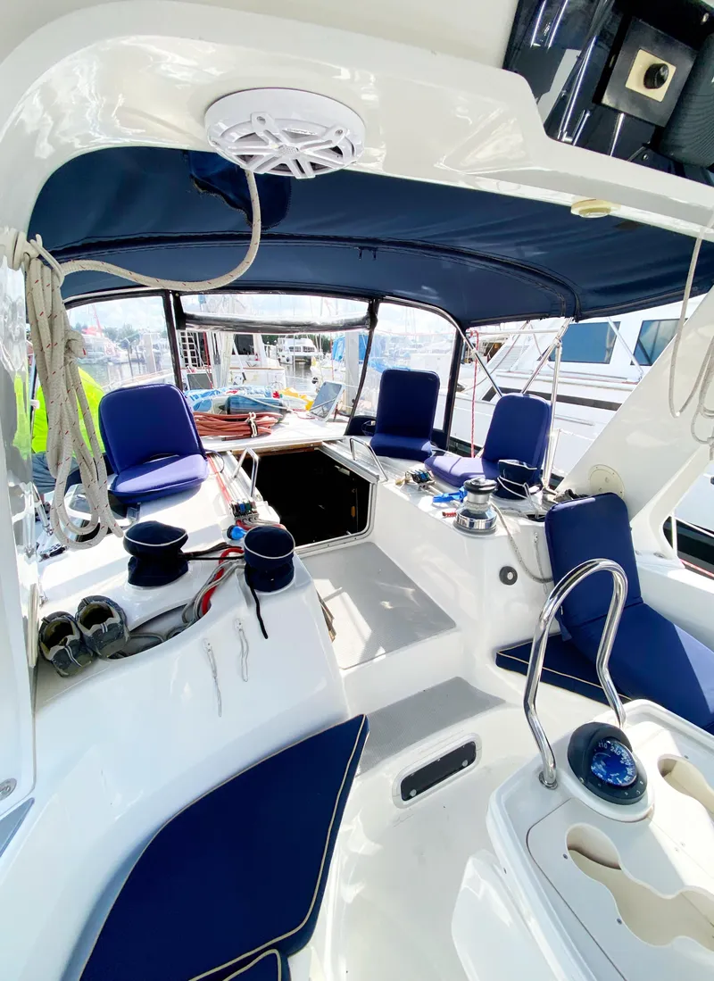 Slide: The Image of 1997 Hunter 430 sailboat cockpit with blue seating and canopy, featuring modern navigation equipment. - 6