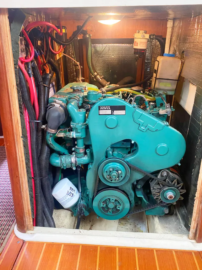 Slide: The Image of 1997 Hunter 430 engine compartment with green marine engine and wiring. - 60