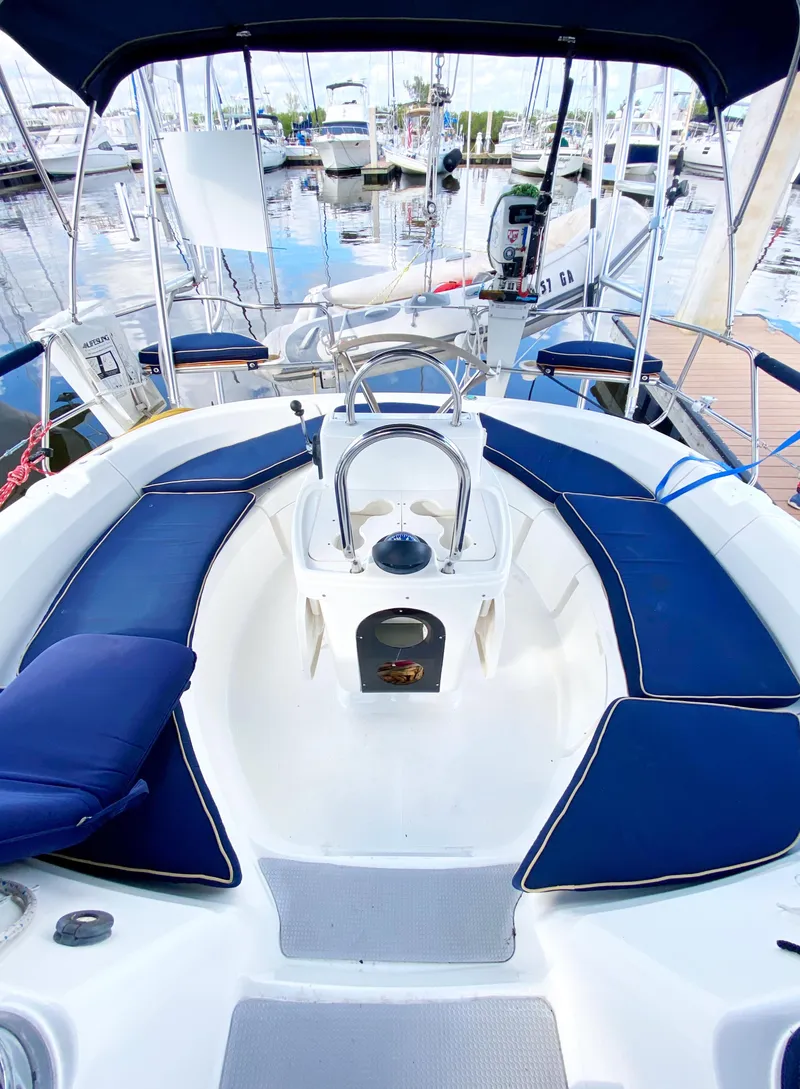 Slide: The Image of Cockpit of a 1997 Hunter 430 sailboat with blue seating and marina view. - 9