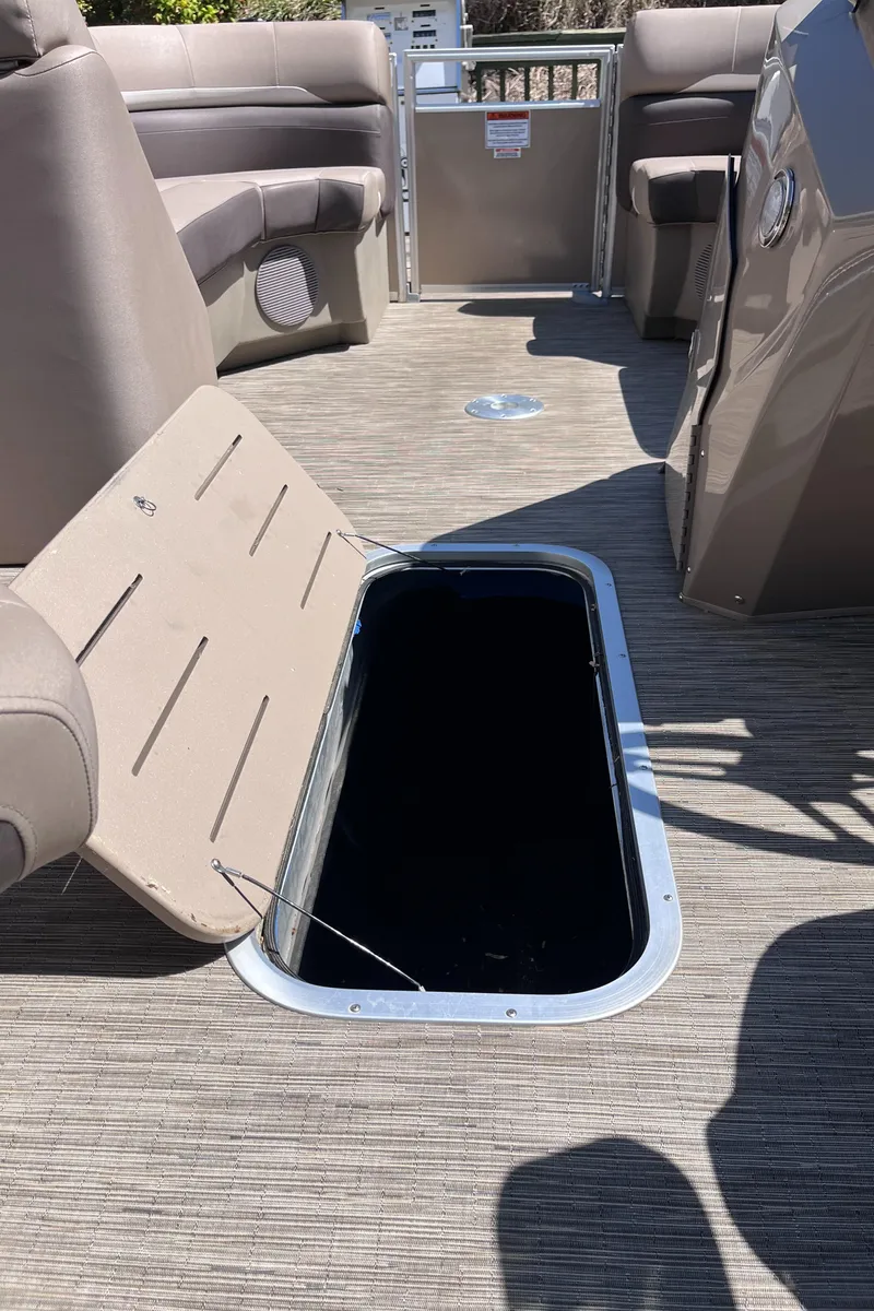 Slide: The Image of 2023 Bennington 22 SXSR boat interior with open storage compartment. - 12