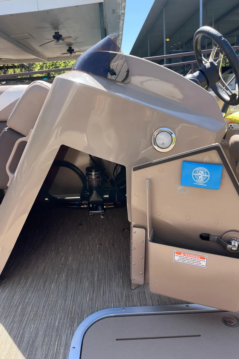 Slide: The Image of 2023 Bennington 22 SXSR boat interior with steering console and seating area. - 13