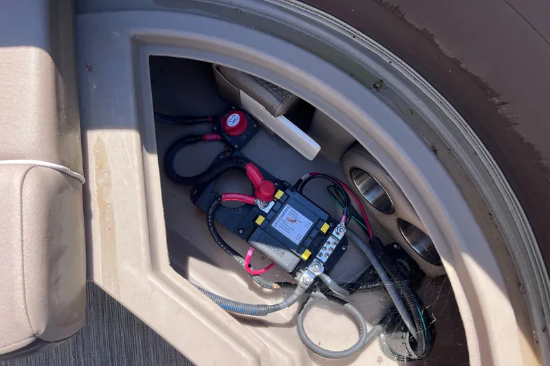 Slide: The Image of 2023 Bennington 22 SXSR boat battery compartment with wiring and connections. - 14
