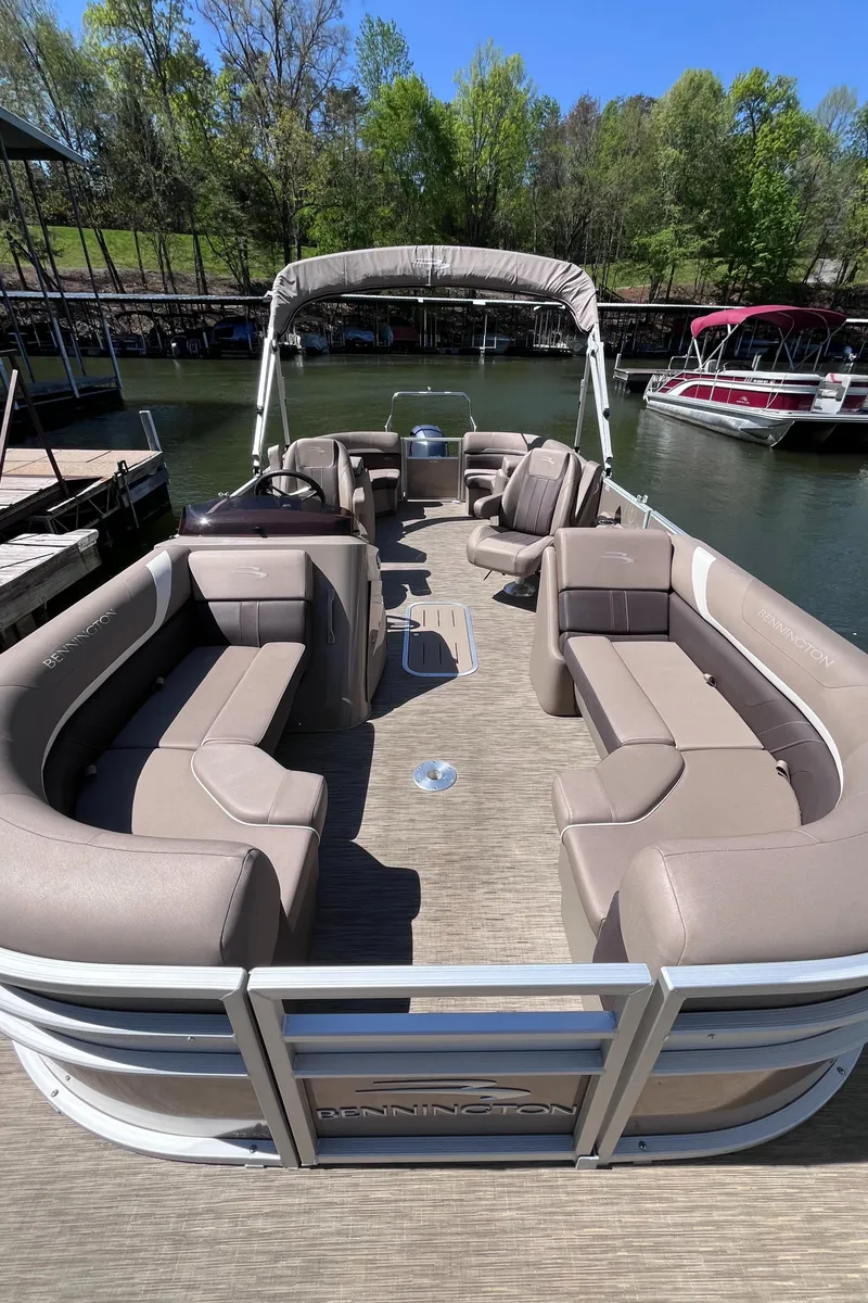 Slide: The Image of 2023 Bennington 22 SXSR pontoon boat with spacious seating on a sunny dock. - 4