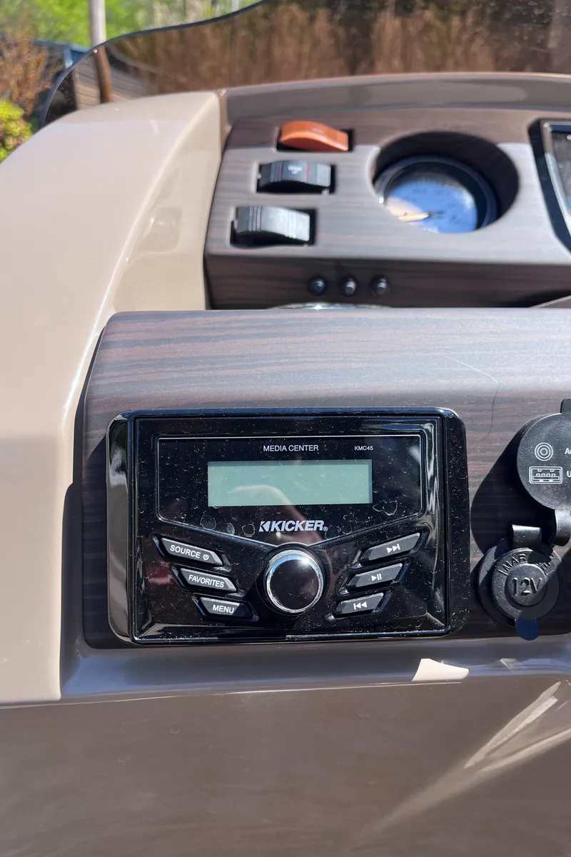 Slide: The Image of 2023 Bennington 22 SXSR boat dashboard with audio controls and gauges. - 7