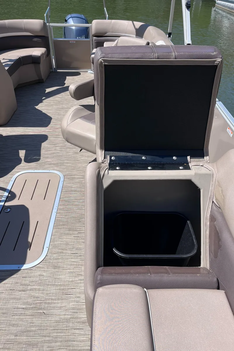 Slide: The Image of 2023 Bennington 22 SXSR boat interior with open storage compartment on deck. - 9