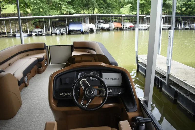 Slide: The Image of 2024 Avalon Catalina Funship 25' boat interior with Garmin navigation system at dock. - 11