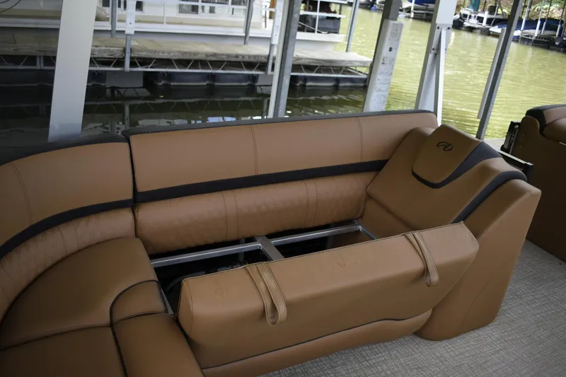 Slide: The Image of 2024 Avalon Catalina Funship 25' interior seating with tan upholstery and black accents. - 15