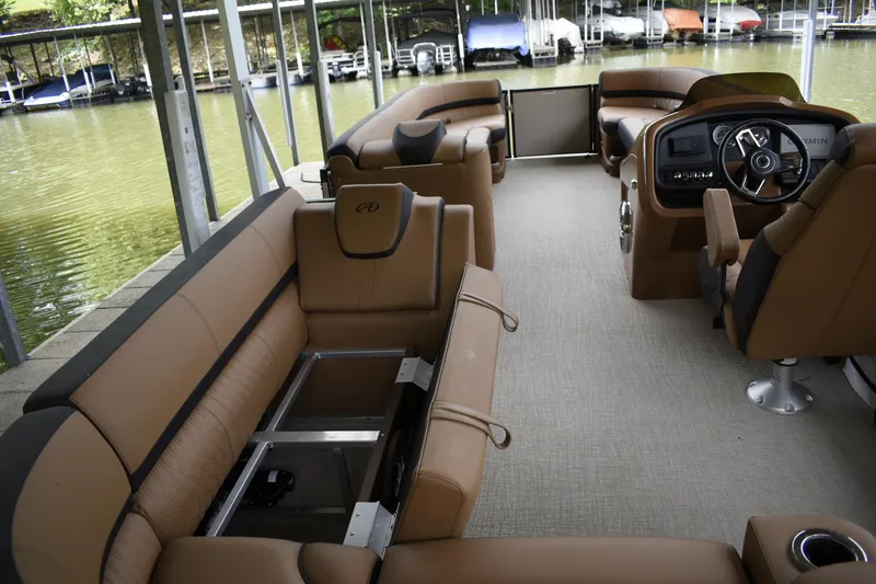 Slide: The Image of 2024 Avalon Catalina Funship 25' interior with tan seating and modern dashboard. - 16