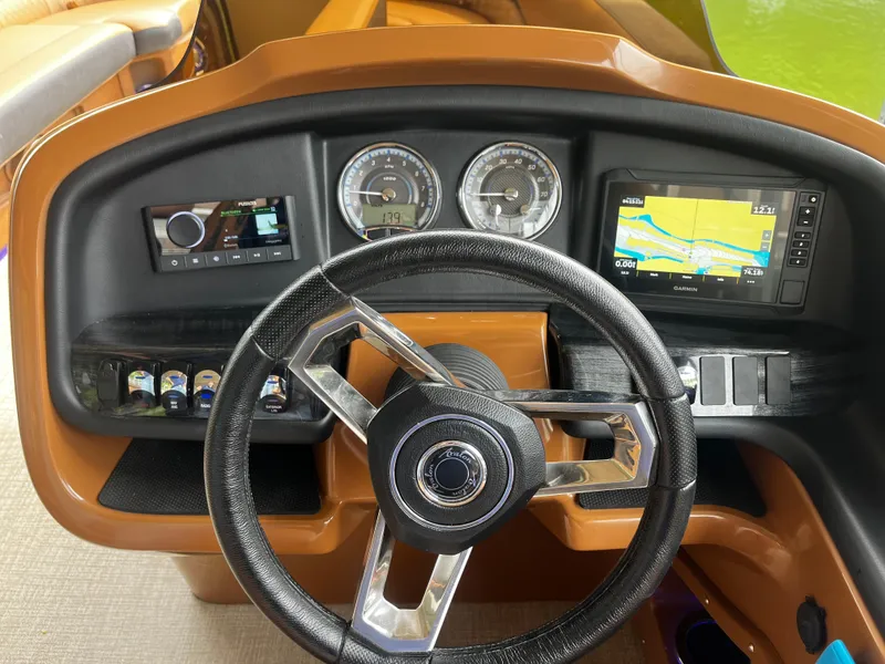 Slide: The Image of Dashboard of 2024 Avalon Catalina Funship 25' with steering wheel, gauges, and navigation screen. - 17