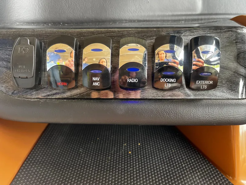 Slide: The Image of Control panel of 2024 Avalon Catalina Funship 25' with various switches. - 22