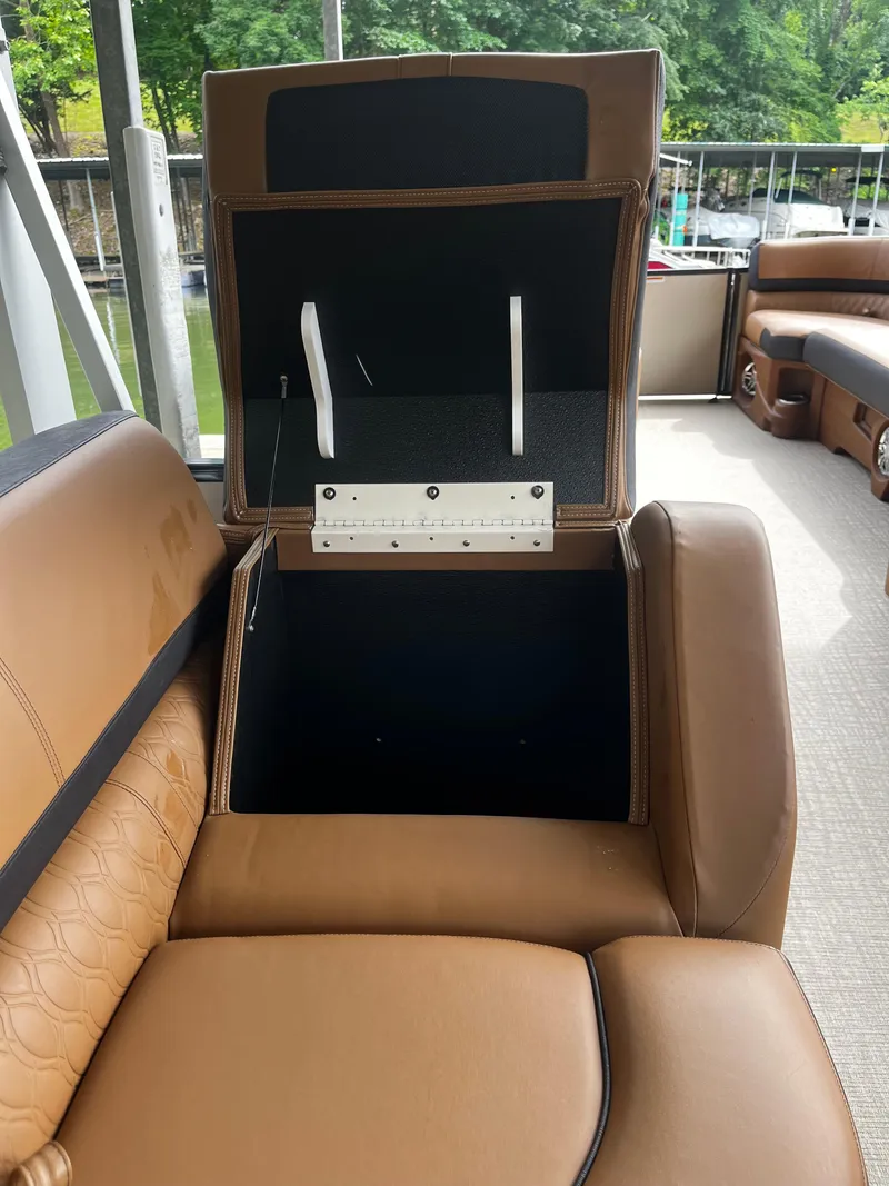 Slide: The Image of Open storage compartment on Avalon Catalina Funship 25' 2024 boat with brown leather seating. - 32