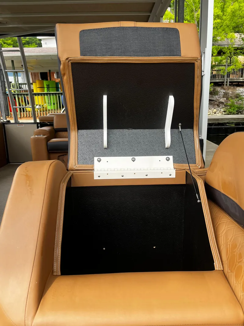 Slide: The Image of 2024 Avalon Catalina Funship 25' - Open storage compartment in tan leather seat. - 33