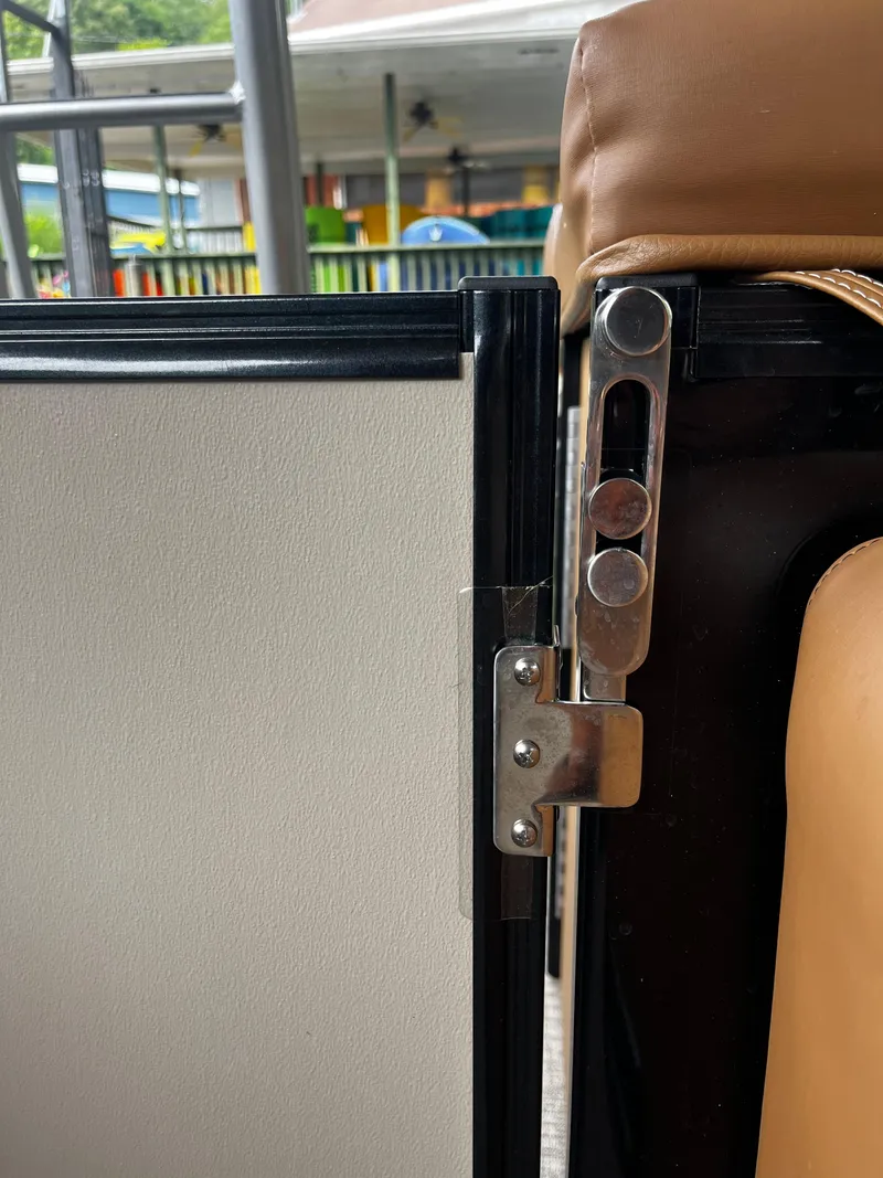 Slide: The Image of Close-up of a latch mechanism on a 2024 Avalon Catalina Funship 25' boat. - 38