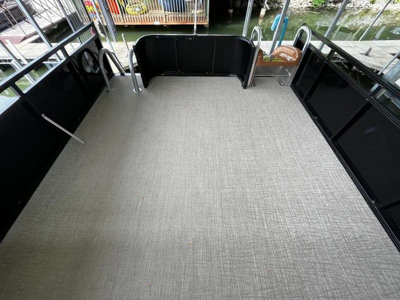 Slide: The Image of 2024 Avalon Catalina Funship 25' deck with gray flooring and black railings. - 45