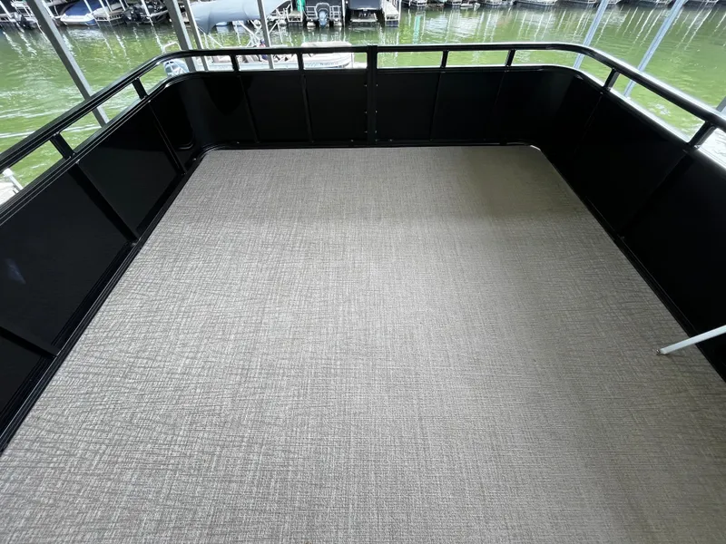 Slide: The Image of 2024 Avalon Catalina Funship 25' deck with black railing and beige flooring. - 46