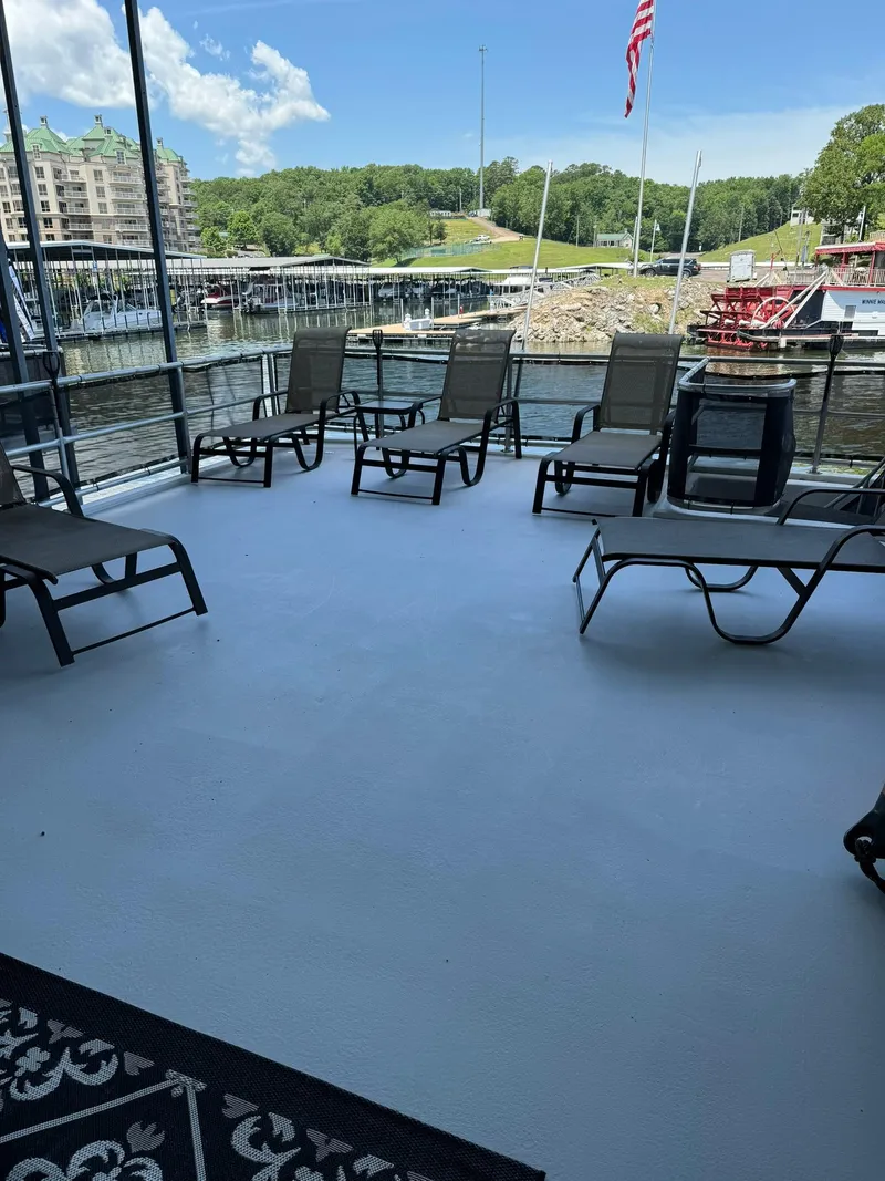 Slide: The Image of Spacious deck on a 2003 Sharpe 75' Houseboat with lounge chairs and scenic marina view. - 10