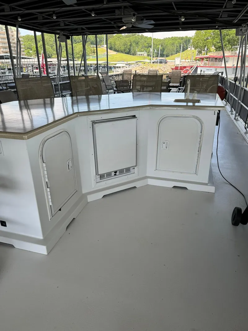 Slide: The Image of 2003 Sharpe 75' Houseboat with outdoor bar and seating area on deck. - 12