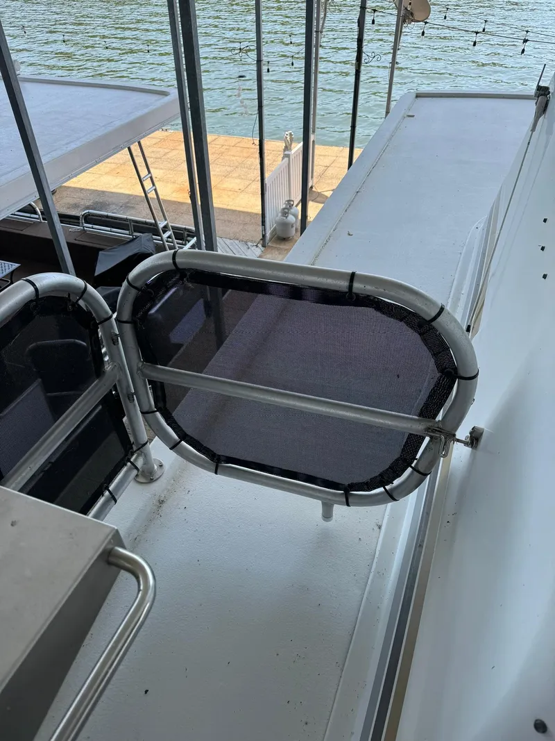 Slide: The Image of 2003 Sharpe 75' Houseboat deck with safety gate and water view. - 15