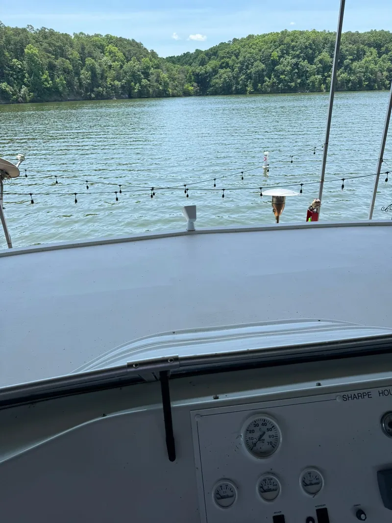 Slide: The Image of View from the helm of a 2003 Sharpe 75' Houseboat on a serene lake. - 16