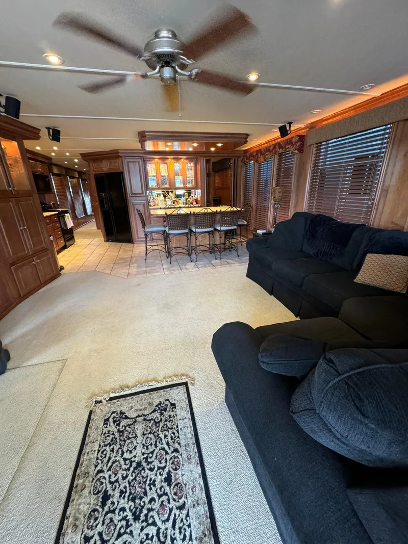 Slide: The Image of Interior of a 2003 Sharpe 75' Houseboat with modern kitchen and cozy living area. - 18