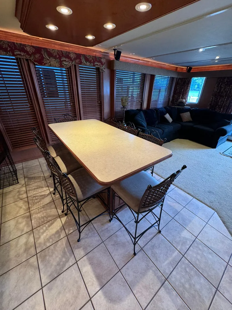 Slide: The Image of Interior of a 2003 Sharpe 75' Houseboat with dining area and lounge. - 25
