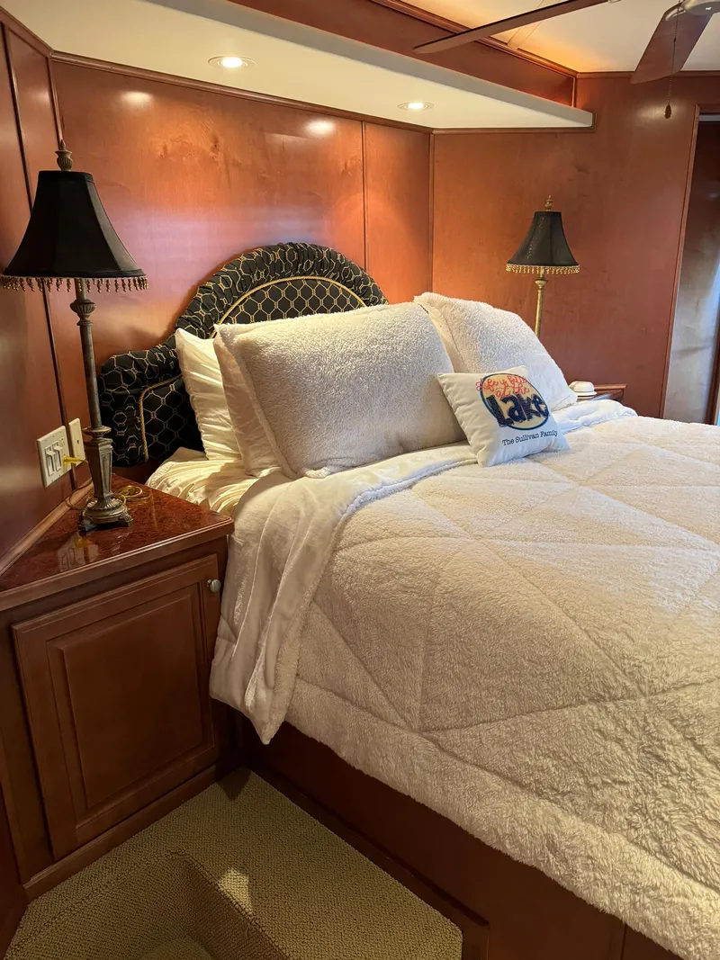 Slide: The Image of Luxurious bedroom interior of a 2003 Sharpe 75' Houseboat with cozy bedding and elegant lighting. - 29