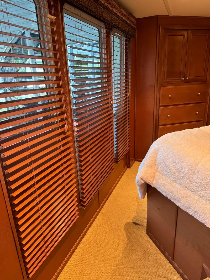 Slide: The Image of Interior of 2003 Sharpe 75' Houseboat with wooden blinds and cozy bedroom. - 30