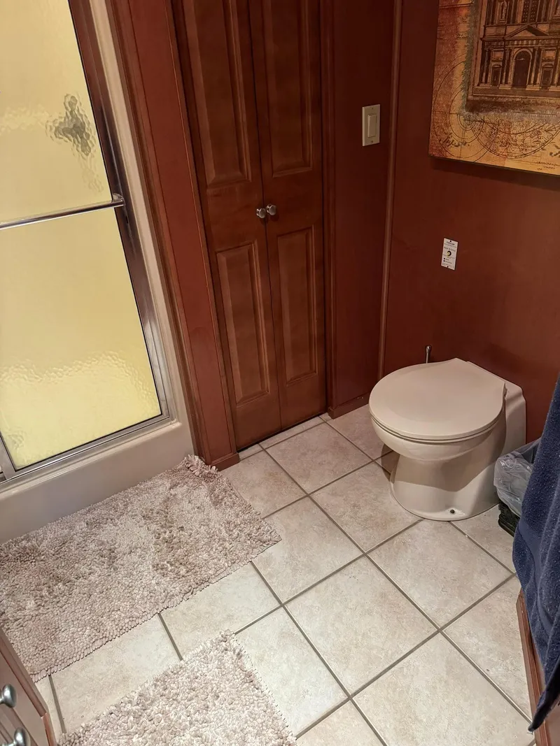 Slide: The Image of Bathroom in a 2003 Sharpe 75' Houseboat with shower, toilet, and tiled floor. - 33