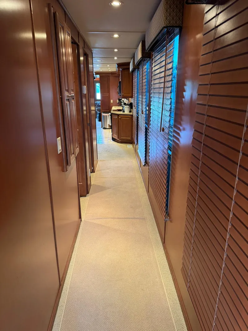 Slide: The Image of Interior hallway of a 2003 Sharpe 75' Houseboat with wooden paneling and carpet. - 34