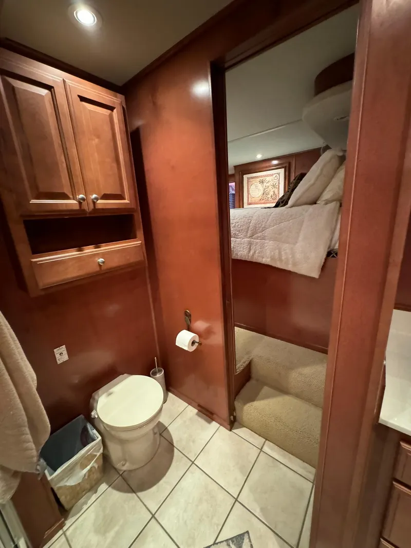Slide: The Image of 2003 Sharpe 75' Houseboat bathroom with wooden cabinets and tiled floor. - 40