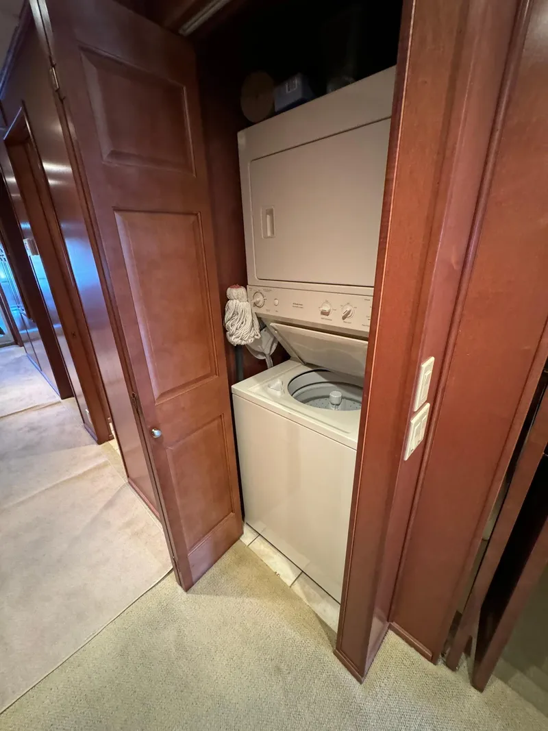 Slide: The Image of Compact laundry area in a 2003 Sharpe 75' Houseboat with stacked washer and dryer. - 42