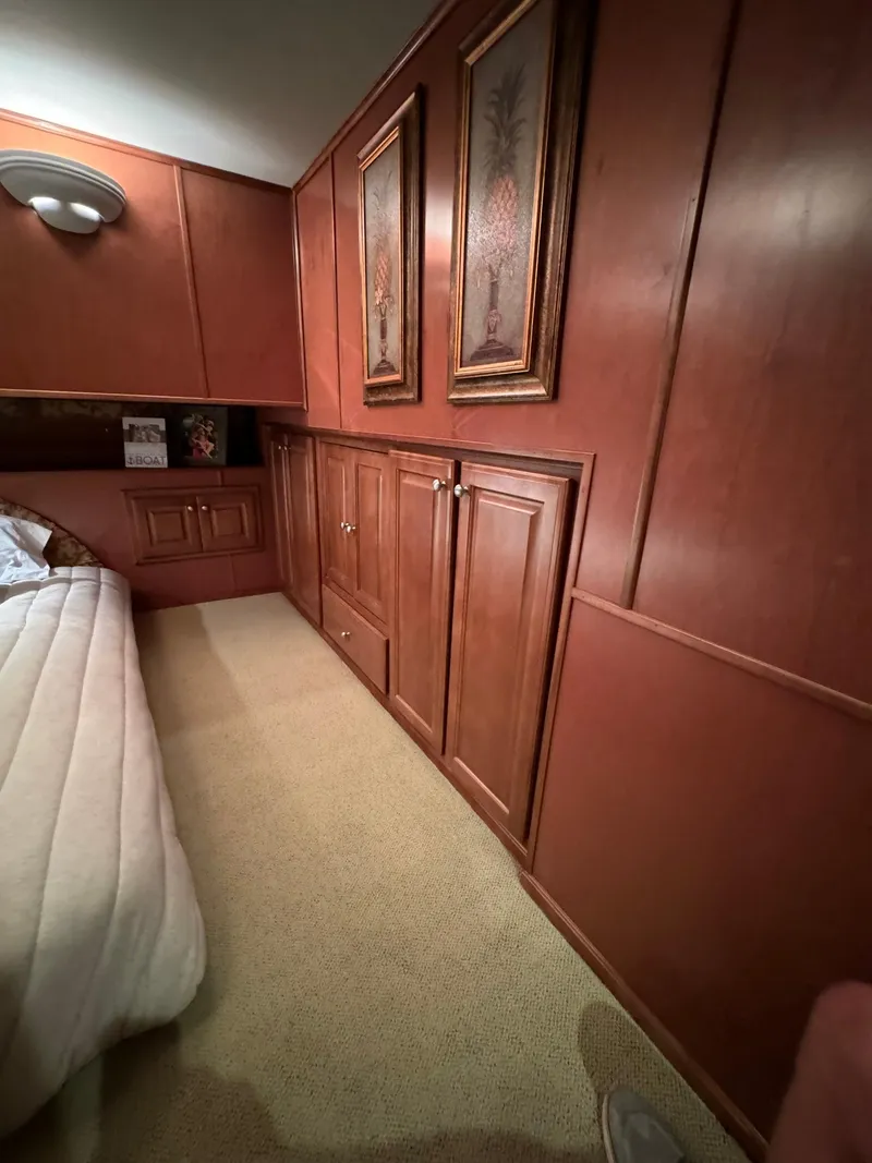 Slide: The Image of Interior bedroom of a 2003 Sharpe 75' Houseboat with wooden cabinets and wall art. - 45
