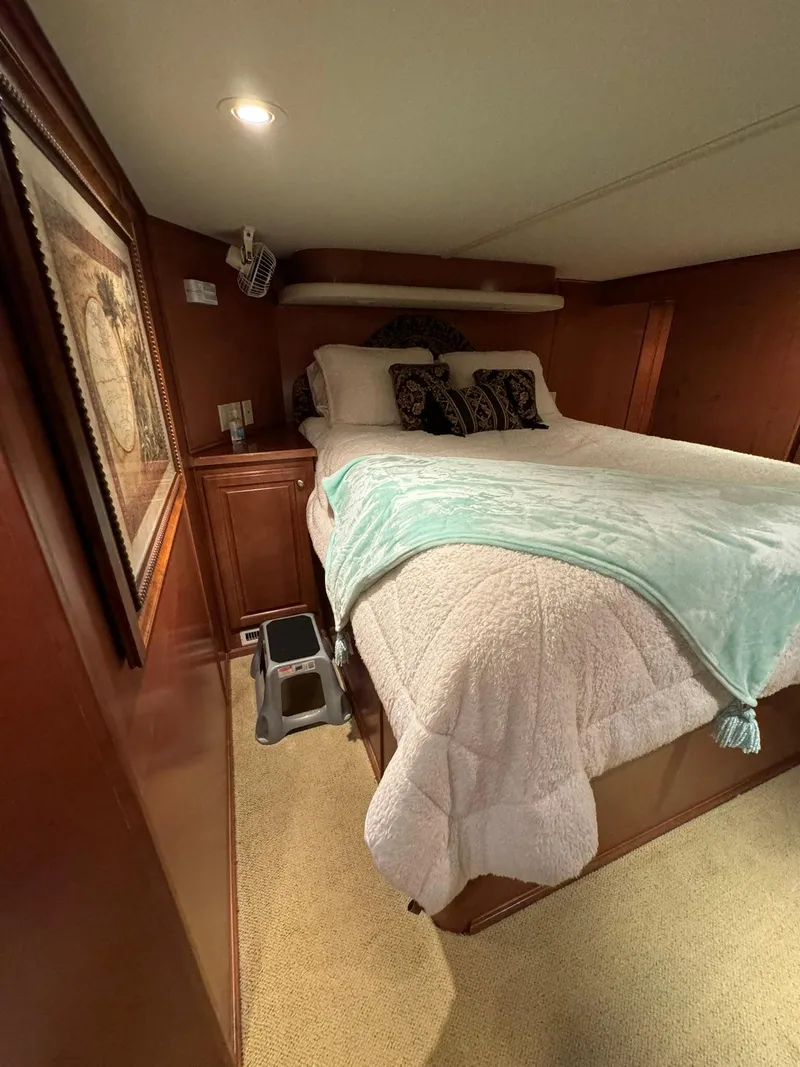 Slide: The Image of Cozy bedroom in a 2003 Sharpe 75' Houseboat with a neatly made bed. - 47
