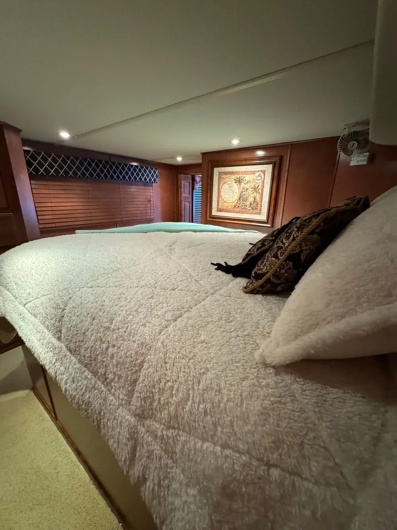 Slide: The Image of Luxurious bedroom interior of a 2003 Sharpe 75' Houseboat with cozy bedding and elegant decor. - 48