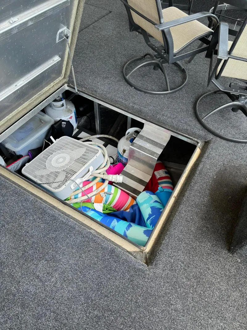 Slide: The Image of Storage compartment on 2003 Sharpe 75' Houseboat with fan, blankets, and chairs. - 49