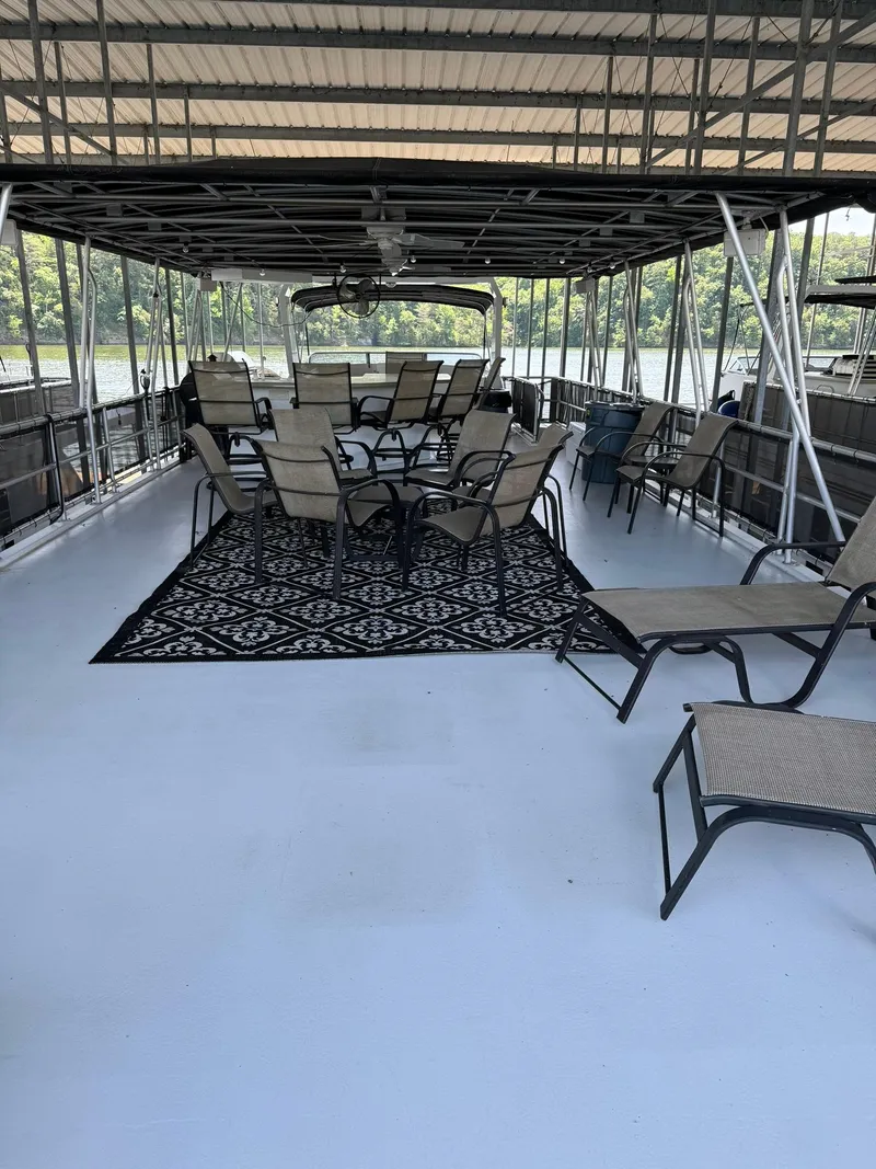 Slide: The Image of Spacious deck of a 2003 Sharpe 75' Houseboat with outdoor seating and a rug. - 5