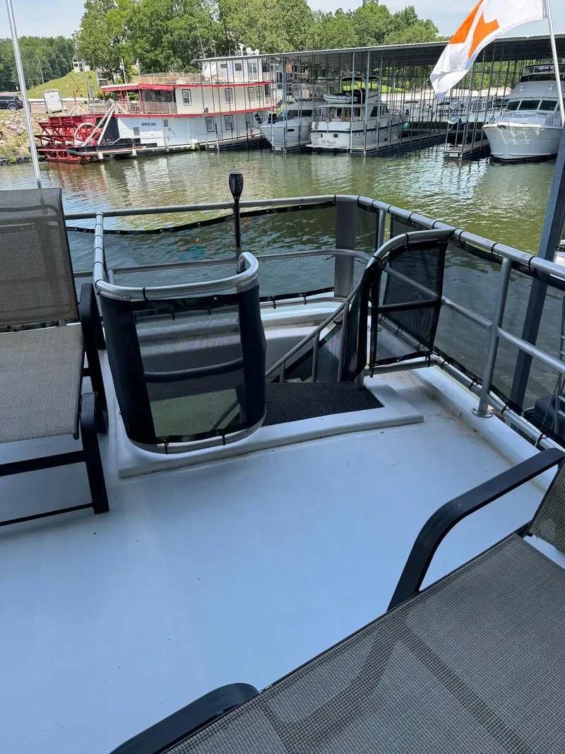 Slide: The Image of 2003 Sharpe 75' Houseboat deck with seating, railing, and marina view. - 6
