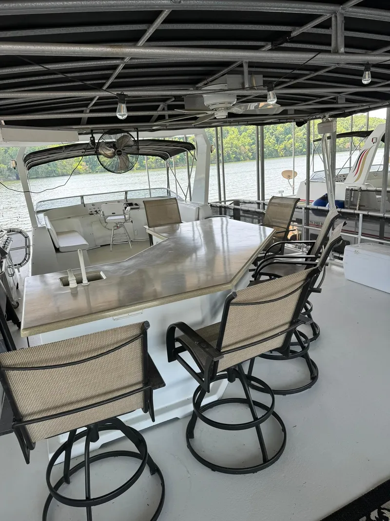 Slide: The Image of 2003 Sharpe 75' Houseboat with outdoor seating and dining area on the deck. - 7