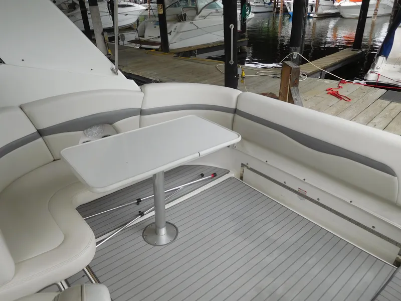 Slide: The Image of 2006 Chaparral 350 Signature boat interior with white seating and table. - 13