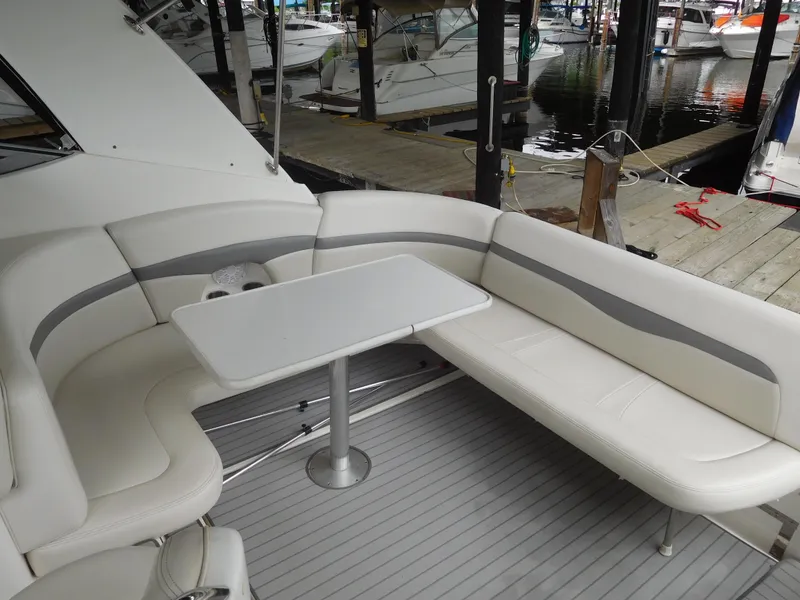 Slide: The Image of 2006 Chaparral 350 Signature boat interior with white seating and table. - 14